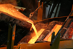 Cupellation furnace casting unrefined silver bullion.